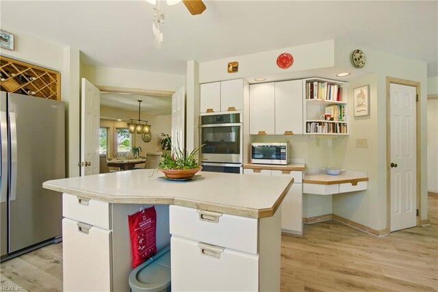 1737 Pleasant Ridge Rd, Virginia Beach, VA 23457 - kitchen featuring appliances with stainless steel finishes, white cabinets, light wood-style flooring, light countertops, and a kitchen island