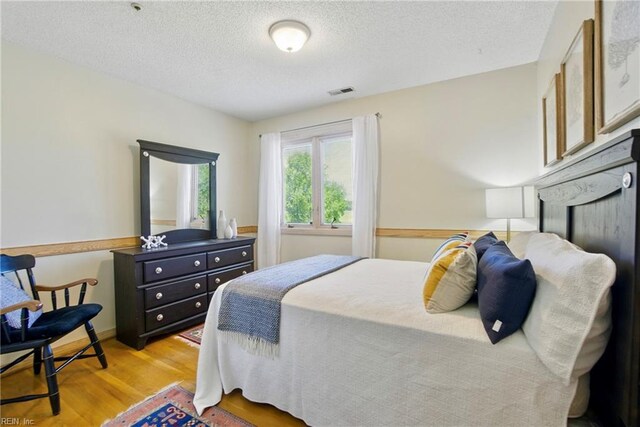 1737 Pleasant Ridge Rd, Virginia Beach, VA 23457 - bedroom with wood finished floors and a textured ceiling