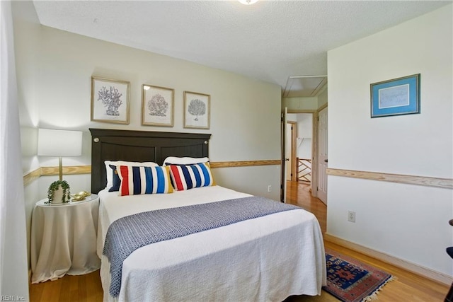 1737 Pleasant Ridge Rd, Virginia Beach, VA 23457 - bedroom featuring wood finished floors, attic access, and a textured ceiling
