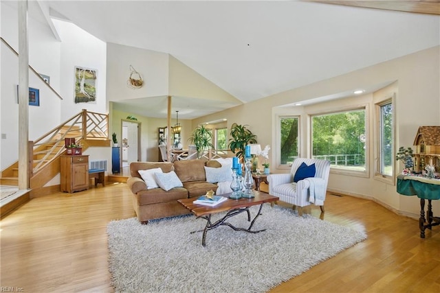 1737 Pleasant Ridge Rd, Virginia Beach, VA 23457 - living room featuring stairs, light wood-style floors, plenty of natural light, and high vaulted ceiling