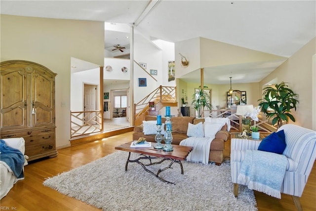 1737 Pleasant Ridge Rd, Virginia Beach, VA 23457 - living room featuring wood finished floors, stairway, high vaulted ceiling, ceiling fan, and a chandelier