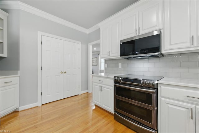 20517 Madison Ct, Smithfield, VA 23430 - kitchen with appliances with stainless steel finishes, ornamental molding, decorative backsplash, and white cabinets