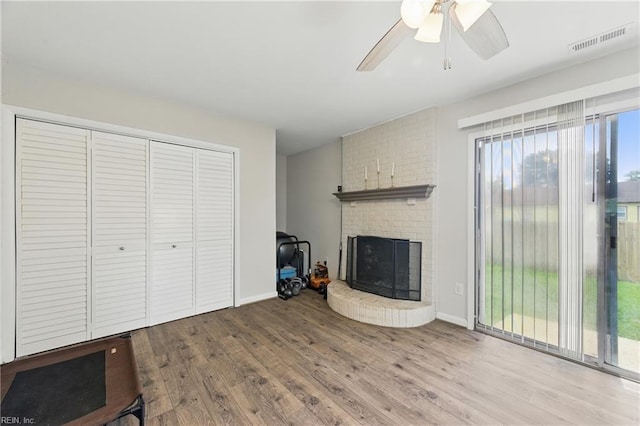1832 Andrews Blvd, Hampton, VA 23663 - unfurnished living room with wood finished floors, a brick fireplace, and ceiling fan