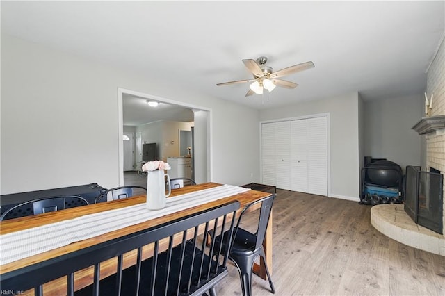 1832 Andrews Blvd, Hampton, VA 23663 - dining space featuring ceiling fan, light wood finished floors, and a brick fireplace