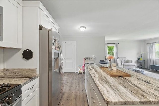 1832 Andrews Blvd, Hampton, VA 23663 - kitchen featuring appliances with stainless steel finishes, a center island, white cabinetry, open floor plan, and plenty of natural light