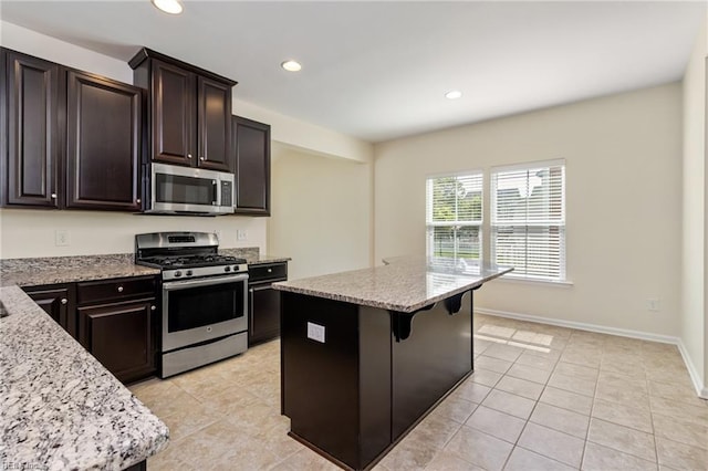 3112 Sybilla St, Chesapeake, VA 23323 - kitchen featuring appliances with stainless steel finishes, light stone counters, a center island, recessed lighting, and light tile patterned flooring
