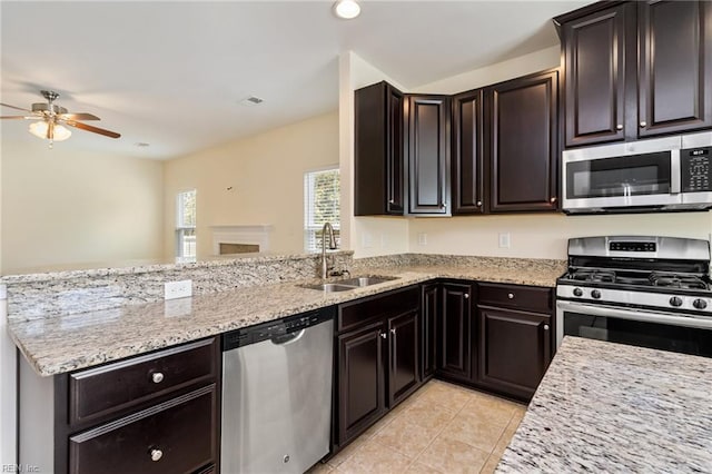 3112 Sybilla St, Chesapeake, VA 23323 - kitchen with appliances with stainless steel finishes, a peninsula, ceiling fan, light tile patterned floors, and light stone countertops