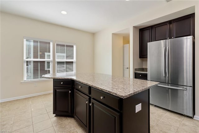 3112 Sybilla St, Chesapeake, VA 23323 - kitchen with freestanding refrigerator, light tile patterned floors, light stone counters, a center island, and recessed lighting