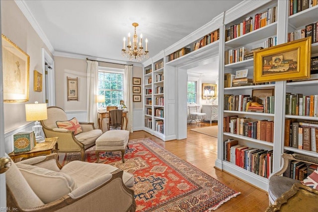537 Cavalier Dr, Virginia Beach, VA 23451 - sitting room with a chandelier, healthy amount of natural light, crown molding, built in shelves, and wood finished floors