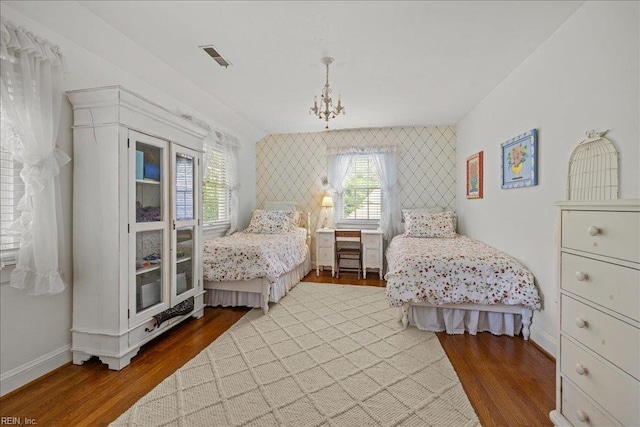537 Cavalier Dr, Virginia Beach, VA 23451 - bedroom featuring an accent wall, multiple windows, a chandelier, and wood finished floors