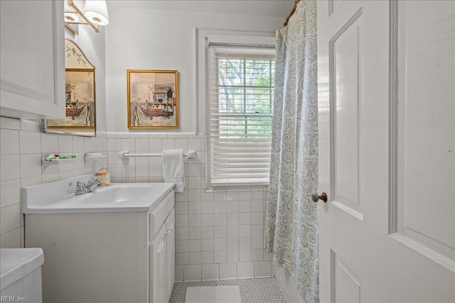 537 Cavalier Dr, Virginia Beach, VA 23451 - bathroom featuring vanity, tile walls, wainscoting, tile patterned floors, and curtained shower