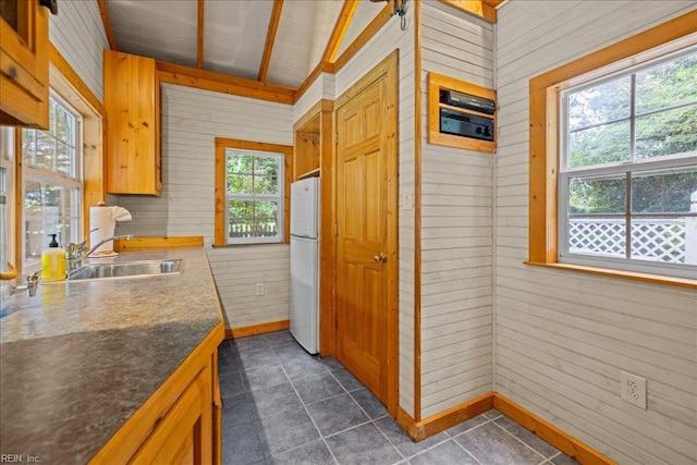537 Cavalier Dr, Virginia Beach, VA 23451 - kitchen with freestanding refrigerator, healthy amount of natural light, wooden walls, dark countertops, and dark tile patterned floors