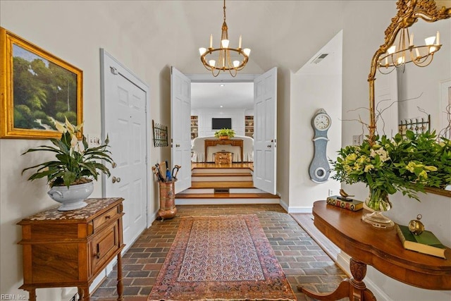 537 Cavalier Dr, Virginia Beach, VA 23451 - foyer with a chandelier and brick flooring