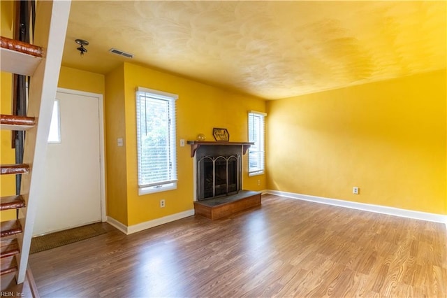 3724 Radford Cir, Chesapeake, VA 23321 - unfurnished living room with a fireplace with raised hearth, plenty of natural light, and wood finished floors