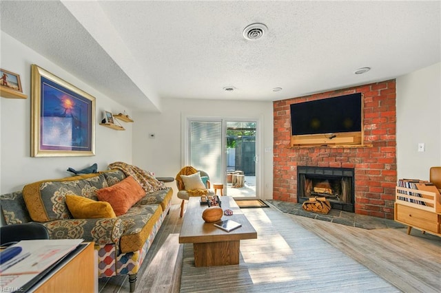 1509 Cypress Ave, Virginia Beach, VA 23451 - living area with a textured ceiling, wood finished floors, and a fireplace