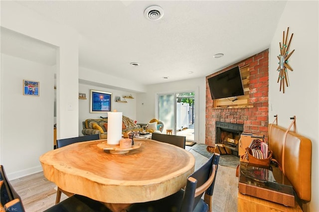 1509 Cypress Ave, Virginia Beach, VA 23451 - dining room featuring light wood finished floors and a fireplace