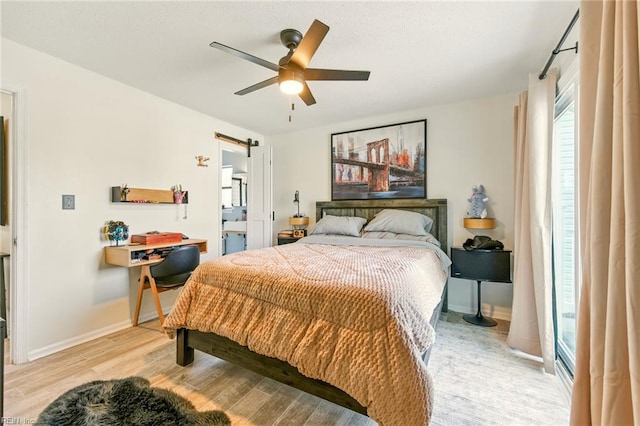 1509 Cypress Ave, Virginia Beach, VA 23451 - bedroom with light wood-type flooring, ceiling fan, and a barn door