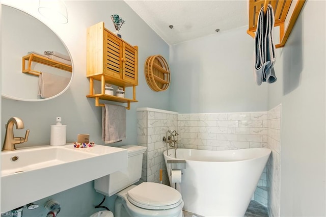 1509 Cypress Ave, Virginia Beach, VA 23451 - bathroom featuring tile walls, a freestanding tub, and wainscoting