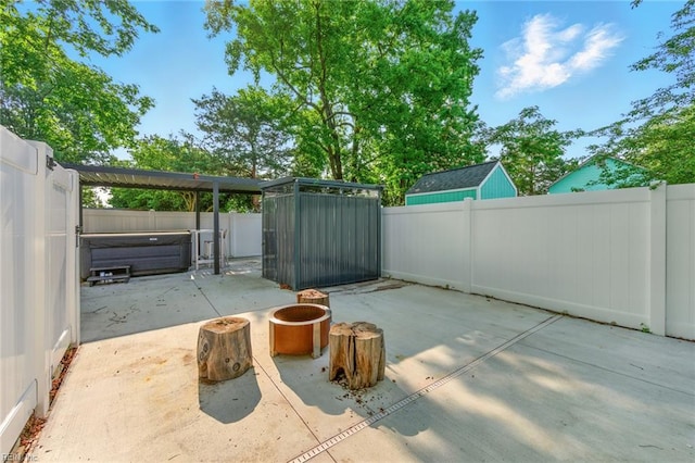 1509 Cypress Ave, Virginia Beach, VA 23451 - fenced backyard featuring a covered hot tub, a patio area, and an outdoor fire pit