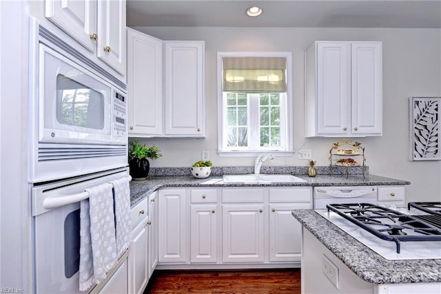 6667 Rexford Ln, Williamsburg, VA 23188 - kitchen with white appliances, white cabinetry, recessed lighting, light stone counters, and dark wood finished floors
