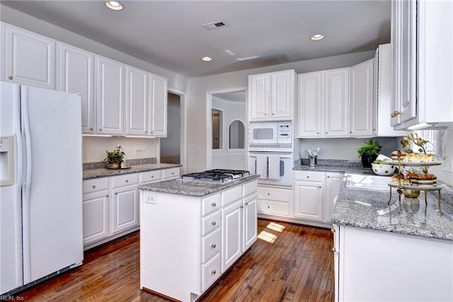 6667 Rexford Ln, Williamsburg, VA 23188 - kitchen featuring white appliances, dark wood-style flooring, white cabinets, and recessed lighting