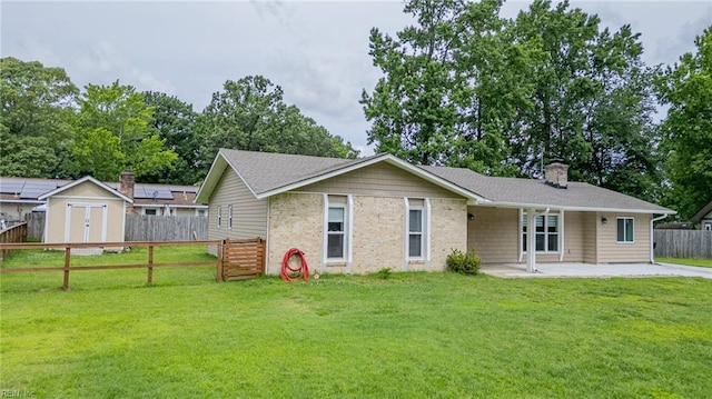 2504 Pine Needles Cir, Virginia Beach, VA 23453 - view of front of house featuring a patio area, a fenced backyard, a chimney, and a shed