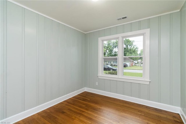 1 N Greenfield Ave, Hampton, VA 23666 - empty room featuring crown molding, dark wood finished floors, and a decorative wall