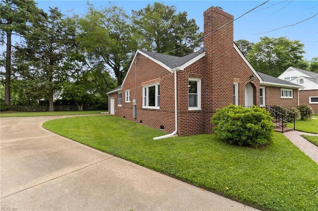 1 N Greenfield Ave, Hampton, VA 23666 - view of home's exterior featuring brick siding, a chimney, a lawn, and crawl space