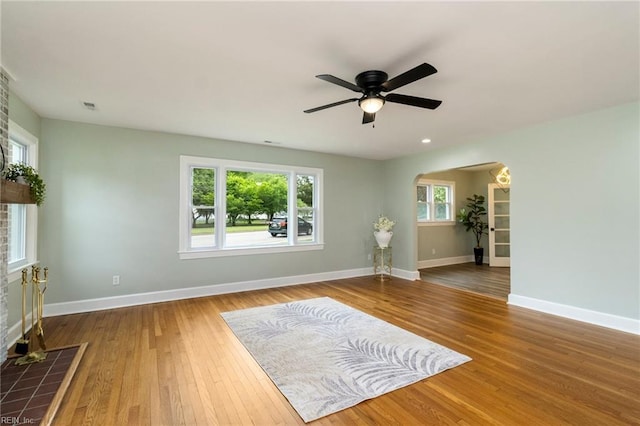 1 N Greenfield Ave, Hampton, VA 23666 - unfurnished living room featuring hardwood / wood-style flooring, ceiling fan, arched walkways, and healthy amount of natural light