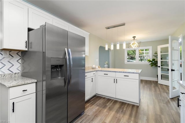 1 N Greenfield Ave, Hampton, VA 23666 - kitchen with stainless steel fridge, a peninsula, wood finished floors, and white cabinets