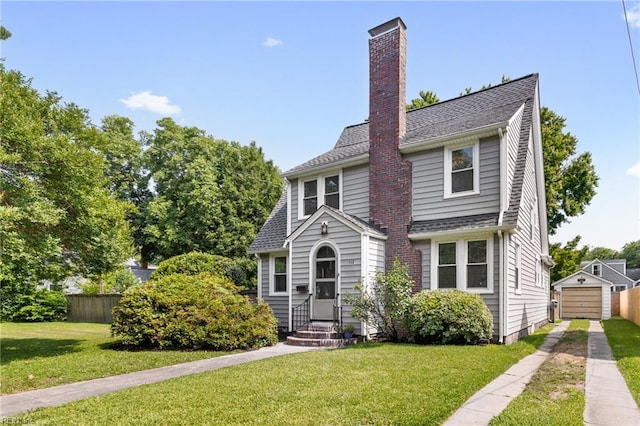 112 Fayton Ave, Norfolk, VA 23505 - view of front of home with driveway, a chimney, a garage, and an outbuilding