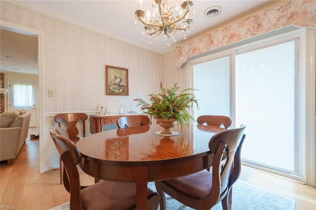 1328 Burlington Rd, Virginia Beach, VA 23464 - dining room with light wood-type flooring, a chandelier, wallpapered walls, and ornamental molding