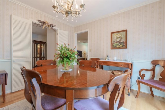 1328 Burlington Rd, Virginia Beach, VA 23464 - dining room with light wood-type flooring, a chandelier, ornamental molding, wallpapered walls, and wainscoting