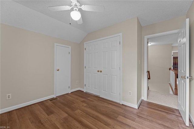 890 Brompton Ct, Newport News, VA 23608 - unfurnished bedroom with wood finished floors, a closet, a ceiling fan, lofted ceiling, and a textured ceiling