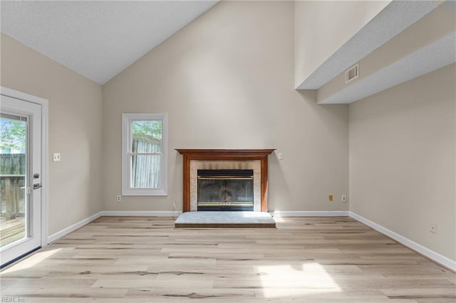 890 Brompton Ct, Newport News, VA 23608 - unfurnished living room featuring light wood-type flooring, healthy amount of natural light, high vaulted ceiling, and a high end fireplace