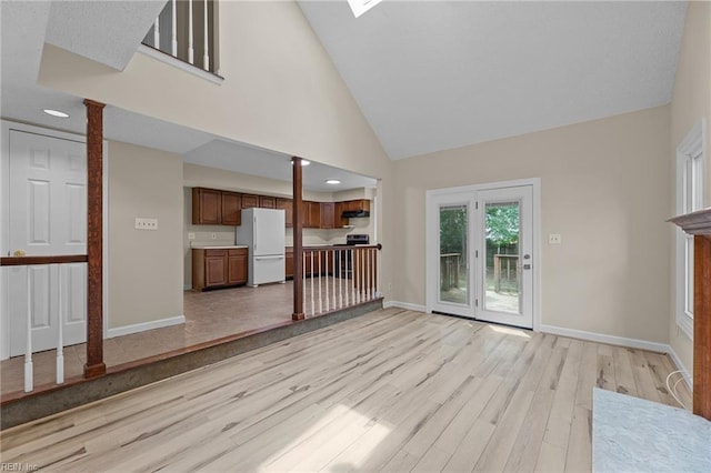 890 Brompton Ct, Newport News, VA 23608 - unfurnished living room featuring light wood-style flooring, high vaulted ceiling, and ornate columns