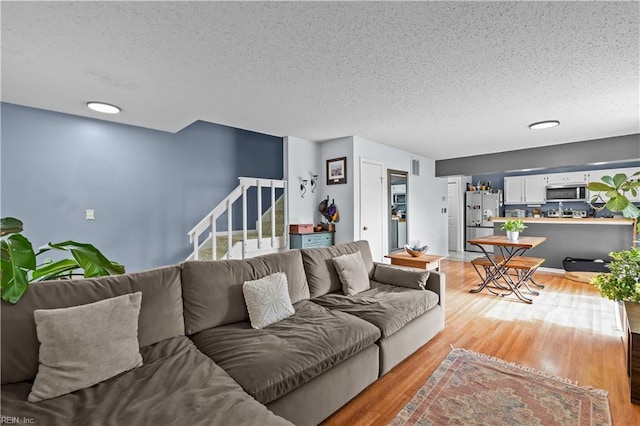 4592 Genoa Cir, Virginia Beach, VA 23462 - living area featuring stairs, a textured ceiling, and light wood-type flooring