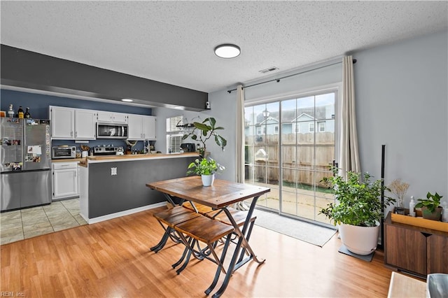 4592 Genoa Cir, Virginia Beach, VA 23462 - dining room featuring light wood-type flooring and a textured ceiling