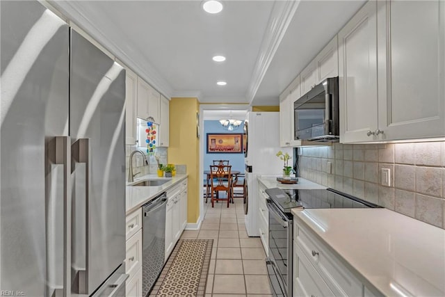 4004 Atlantic Ave Unit 309, Virginia Beach, VA 23451 - kitchen with black appliances, ornamental molding, tasteful backsplash, light countertops, and white cabinetry
