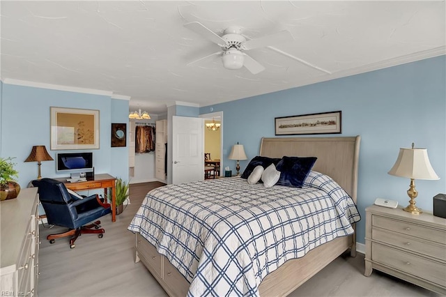 4004 Atlantic Ave Unit 309, Virginia Beach, VA 23451 - bedroom with an office area, a ceiling fan, light wood-type flooring, crown molding, and a chandelier