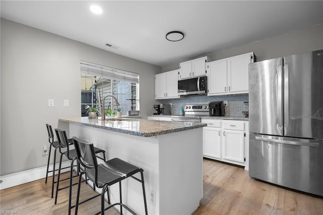 3440 Marabou Ln, Virginia Beach, VA 23451 - kitchen with appliances with stainless steel finishes, light wood-style floors, light stone countertops, and white cabinetry
