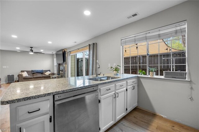 3440 Marabou Ln, Virginia Beach, VA 23451 - kitchen with stainless steel dishwasher, white cabinets, light wood-style floors, plenty of natural light, and recessed lighting