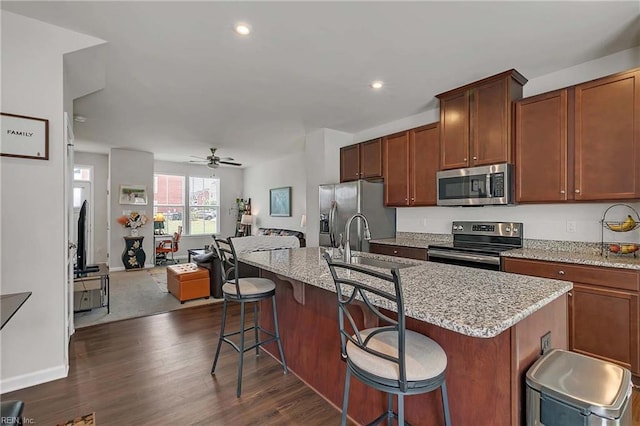 4321 Sconce, Williamsburg, VA 23188 - kitchen featuring stainless steel appliances, open floor plan, ceiling fan, a kitchen island with sink, and dark wood-style floors