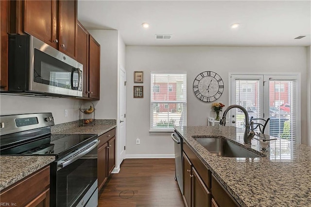 4321 Sconce, Williamsburg, VA 23188 - kitchen with appliances with stainless steel finishes, dark wood finished floors, dark stone countertops, and recessed lighting