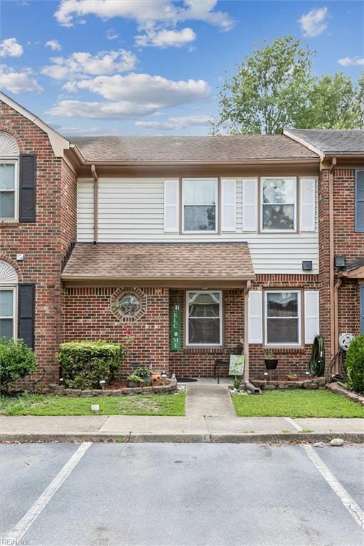 19 Dawn Ln, Hampton, VA 23666 - view of property with uncovered parking, brick siding, and a shingled roof