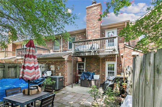 19 Dawn Ln, Hampton, VA 23666 - back of house featuring a balcony, brick siding, a patio, and a chimney