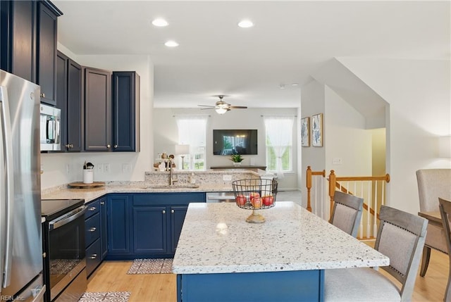 3102 Rollie Way, Chesapeake, VA 23323 - kitchen featuring stainless steel appliances, light wood-style floors, a kitchen island, light stone countertops, and ceiling fan