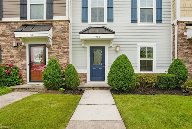 3102 Rollie Way, Chesapeake, VA 23323 - doorway to property with a lawn and stone siding
