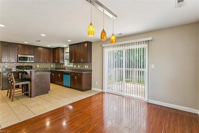 305 Roane Dr, Hampton, VA 23669 - kitchen featuring stainless steel microwave, dishwashing machine, light wood finished floors, dark brown cabinetry, and recessed lighting