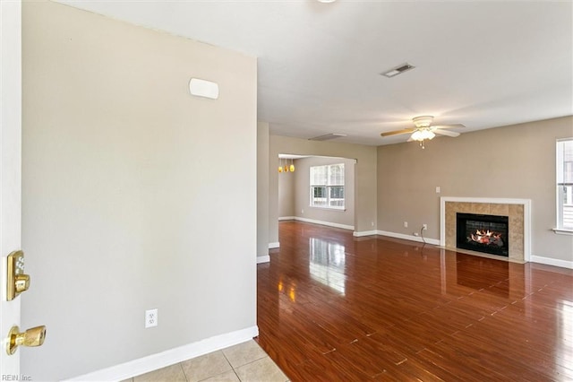 305 Roane Dr, Hampton, VA 23669 - unfurnished living room with ceiling fan, a tile fireplace, and wood finished floors